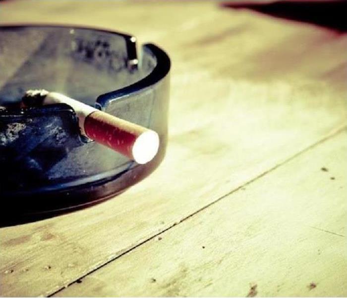 A cigarette in an ashtray, smelling up a room.